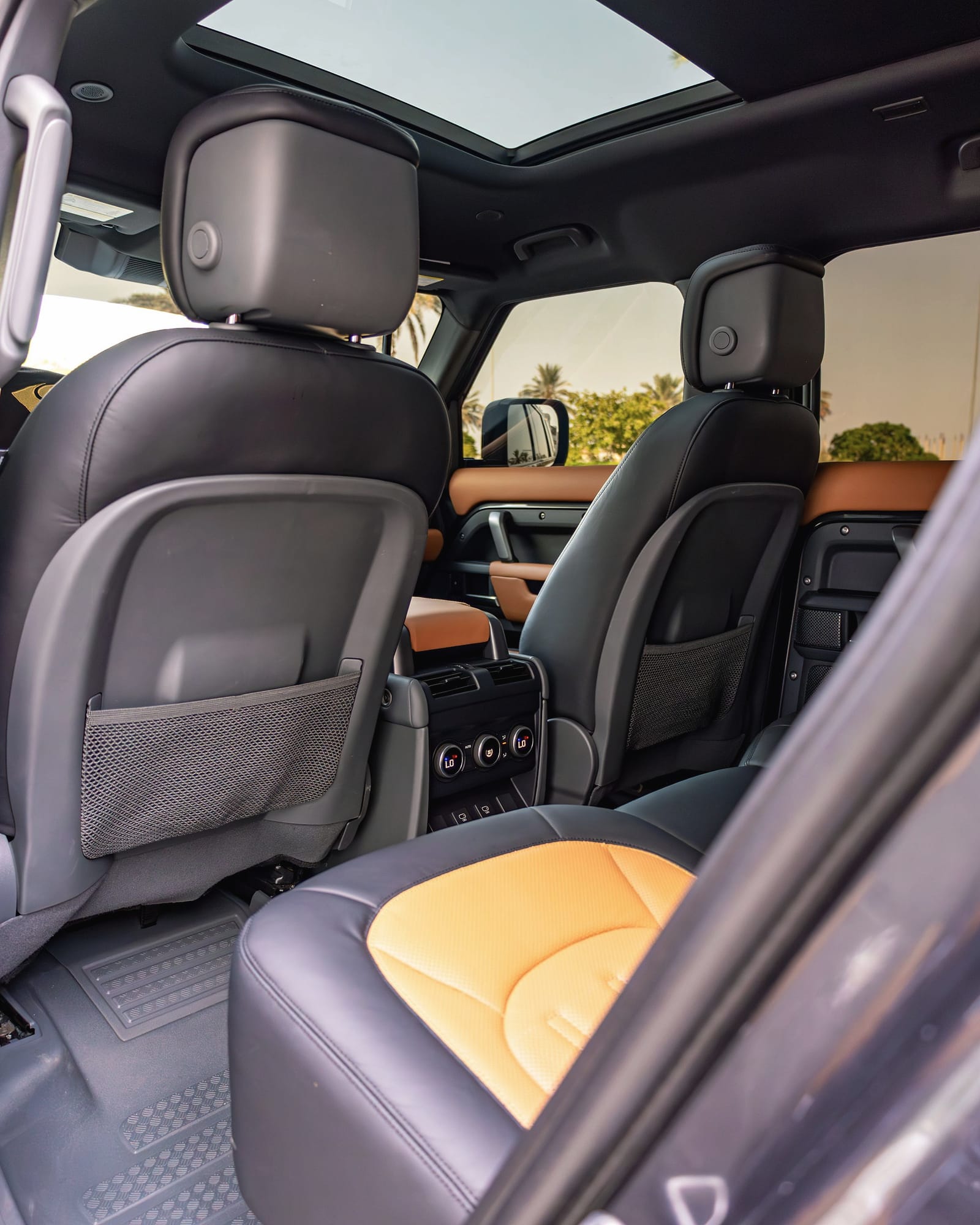 The Defender's rear seats with tan cushions.