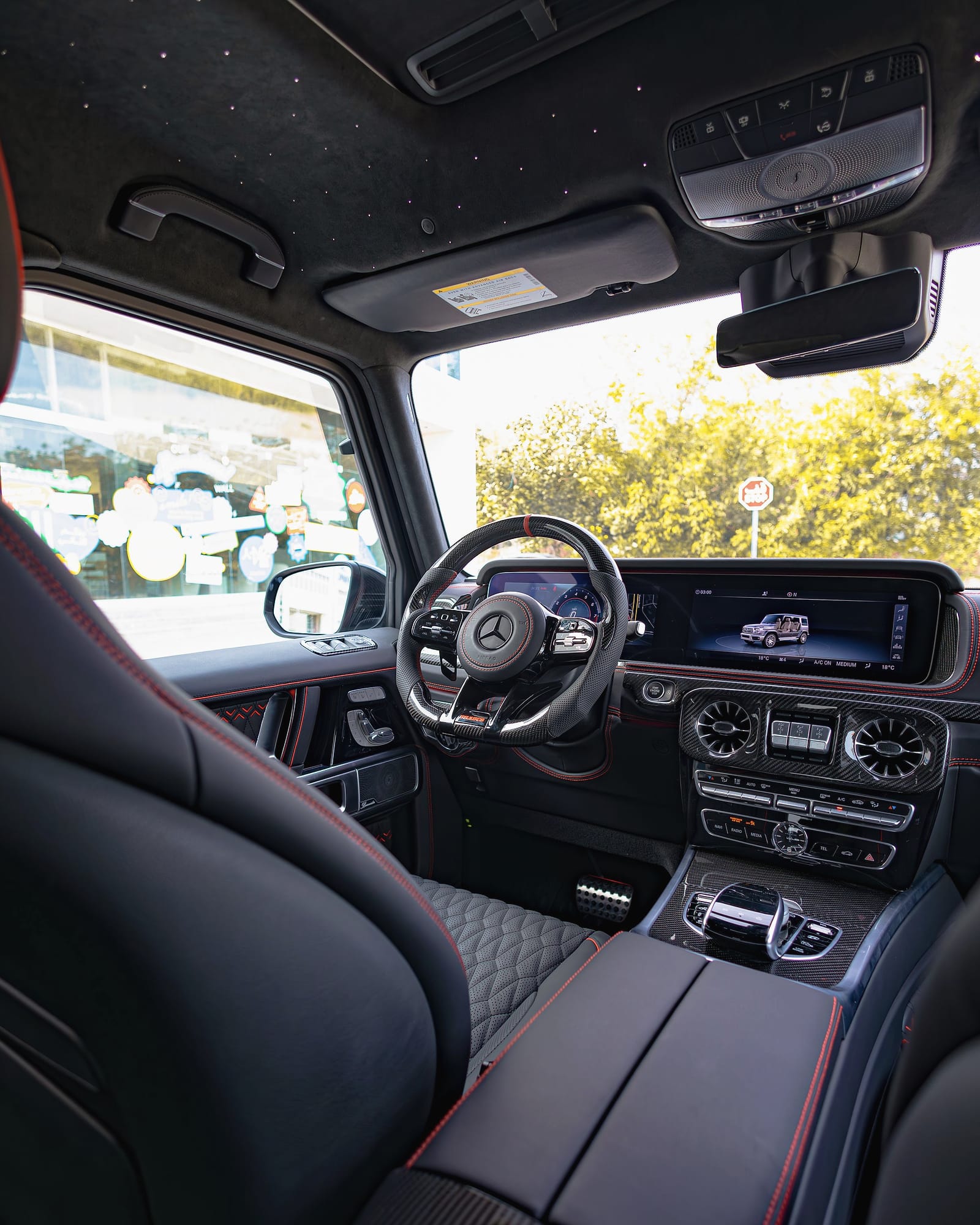 The G-Class cockpit with its wide screens and red stitching.