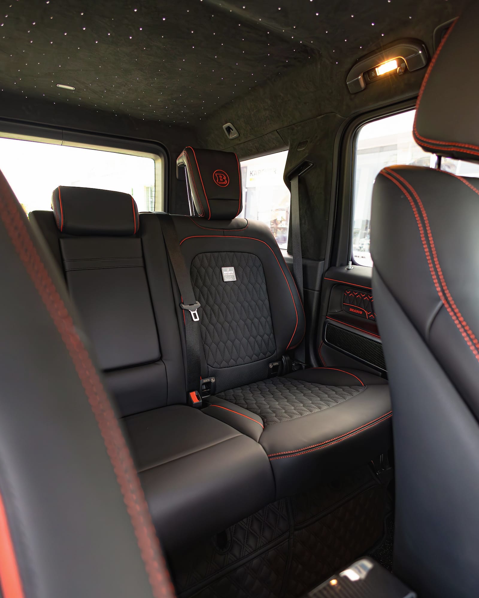 Quilted black leather rear seats with red piping.