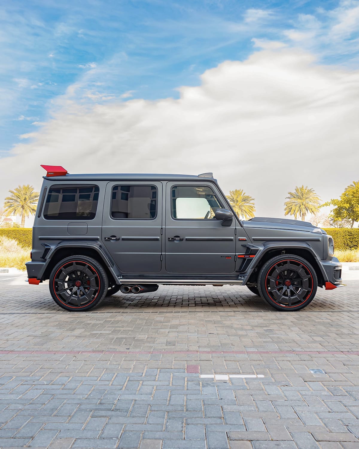 The tuned G-Class in profile, with red-lipped wheels.