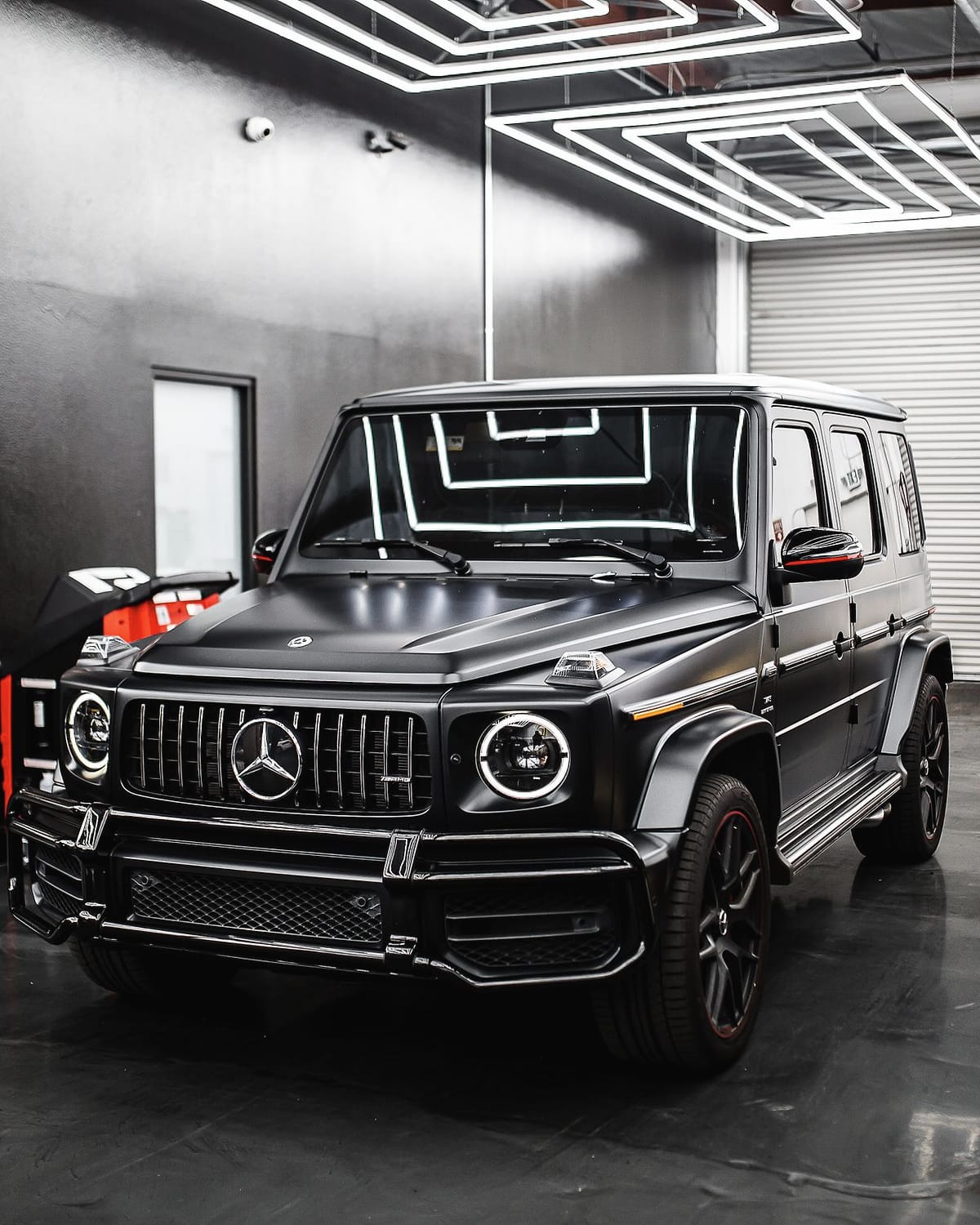 The matte black G 63 in the workshop, from further back.