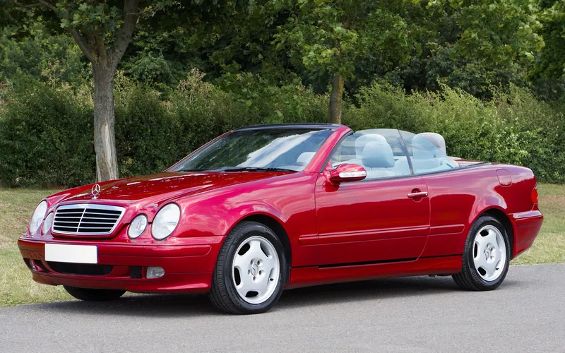 A red Mercedes-Benz CLK Cabriolet with its roof down.